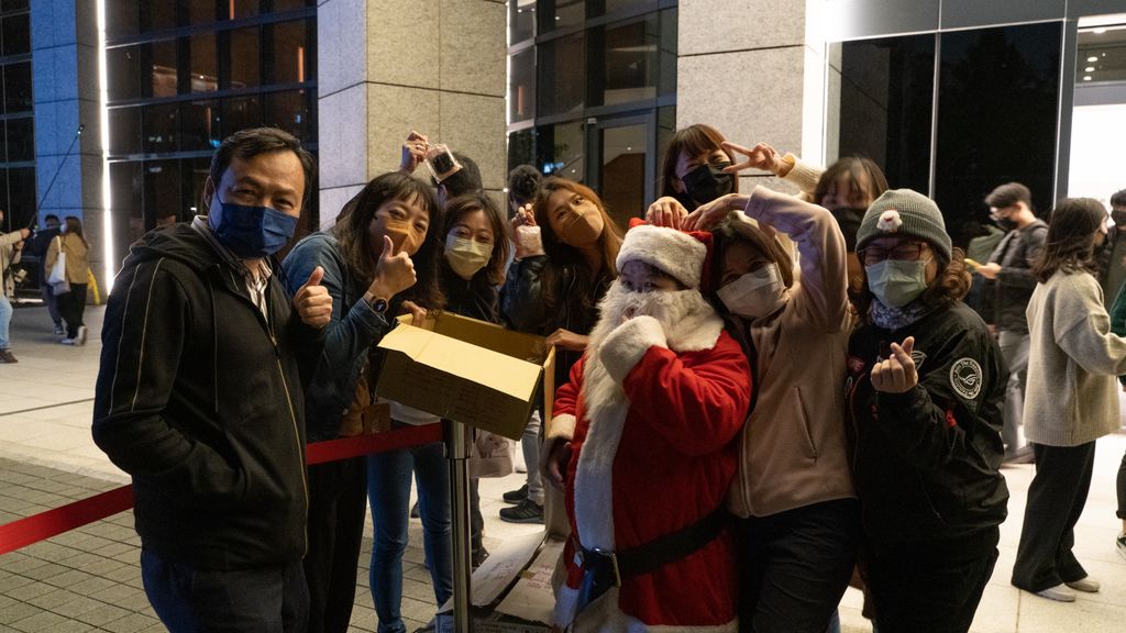 Santa Claus handing out Christmas cookies to employee